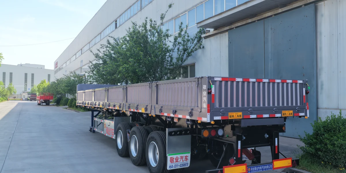 Dropside trailer with grey drop-side panels and three axles