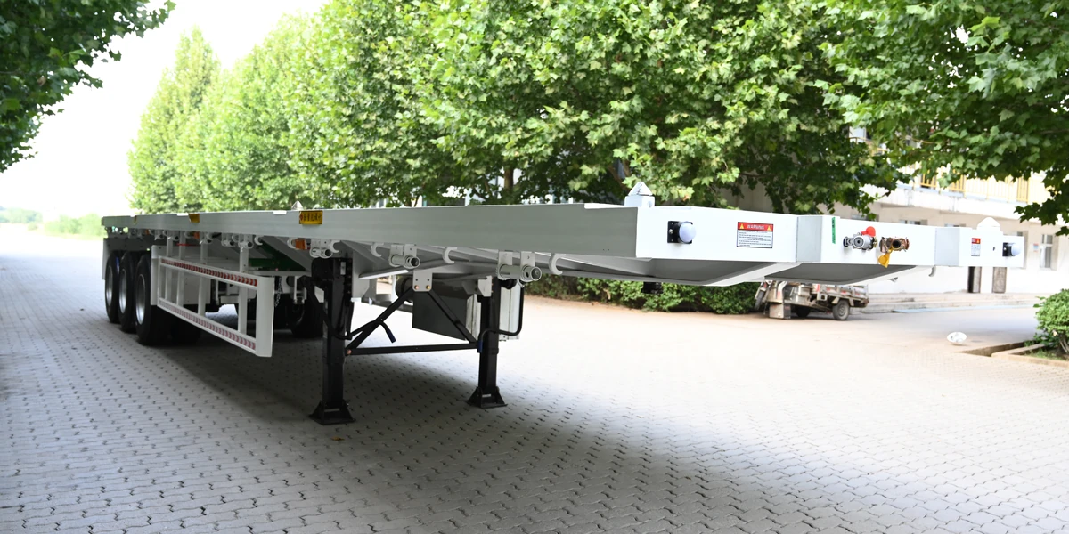 40 ft flatbed semi trailer, front three-quarter view showing the gooseneck and landing legs