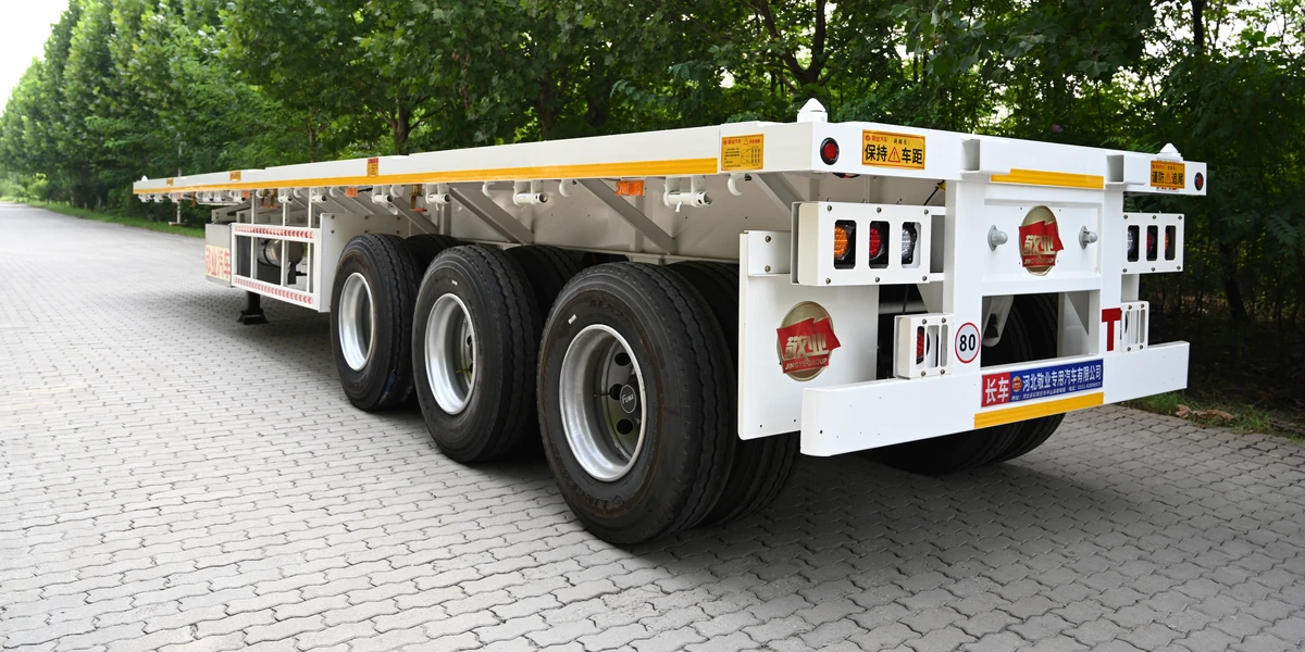 40 ft flatbed semi trailer, rear three-quarter view showing the rear frame and lamp clusters