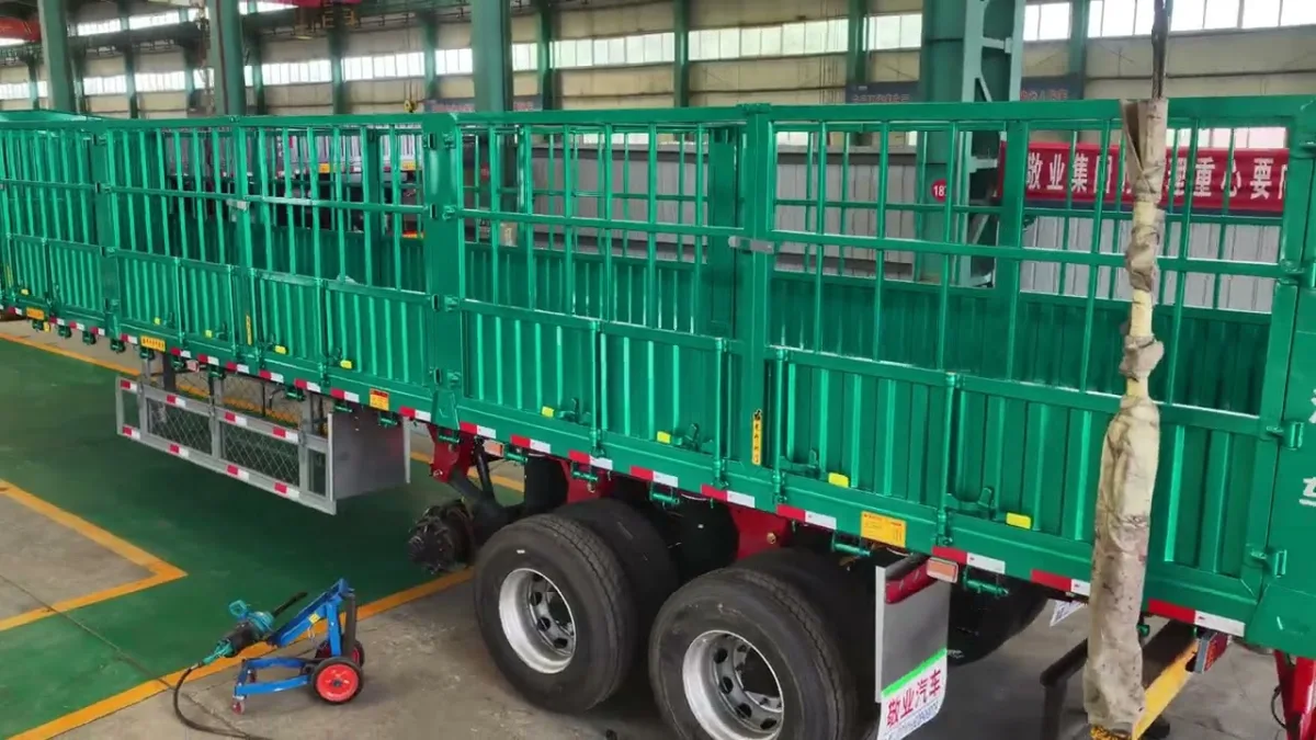 Green fence semi trailers standing in the assembly bay